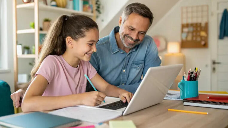 Parent helping his child with homework